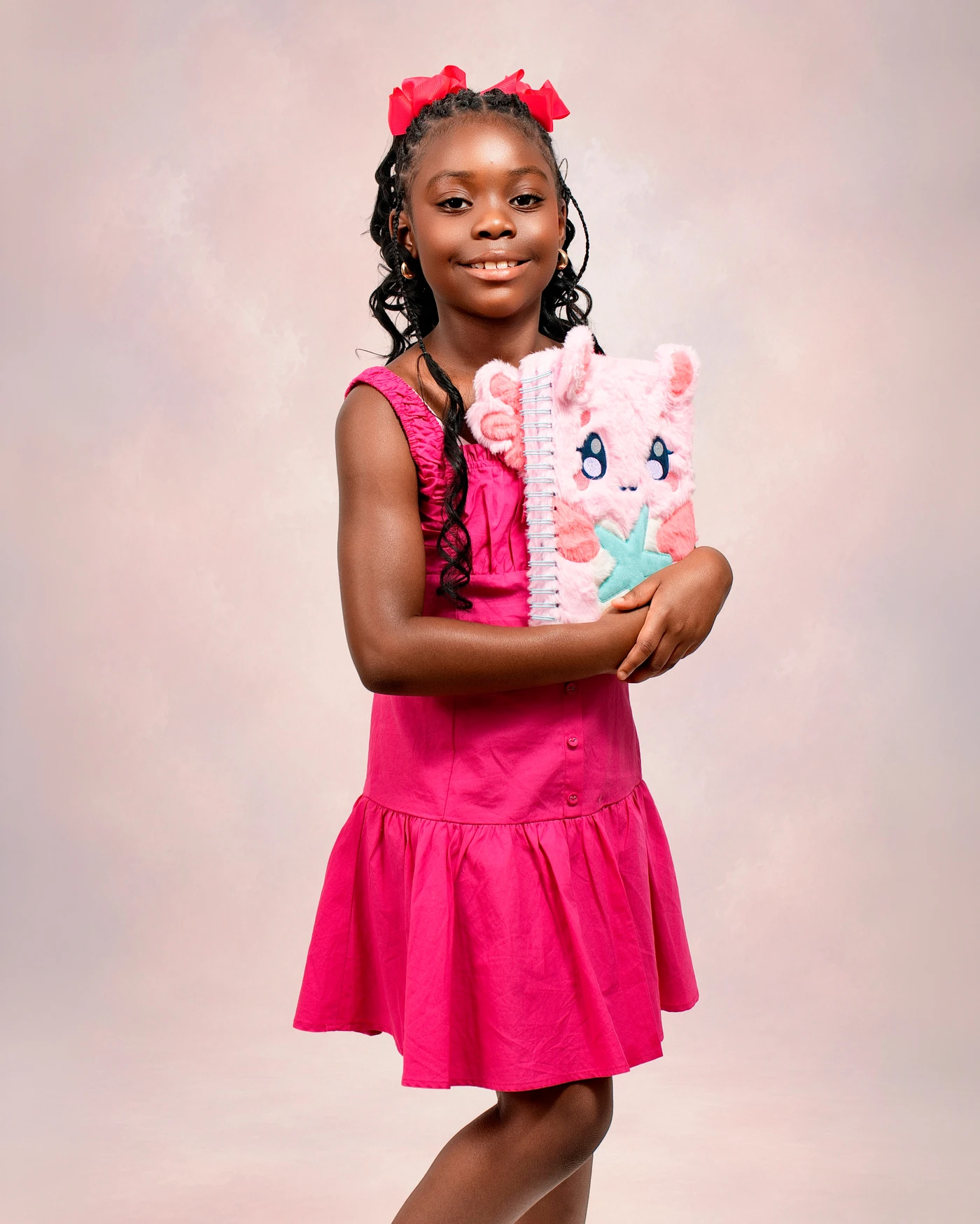 A smiling child holding her favorite notebook