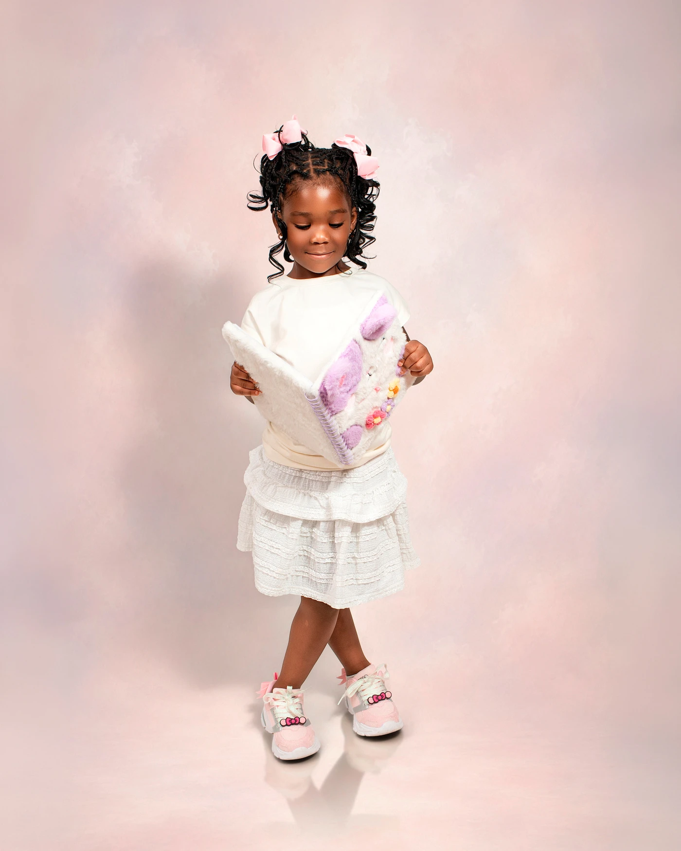 A child reading her fluffy notebook during a portrait session