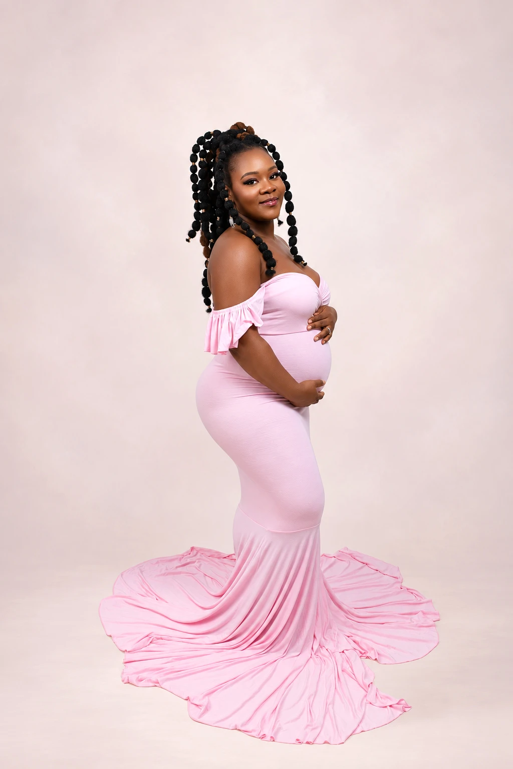 Maternity portrait in a flowing pink gown at Afrikwave Studio