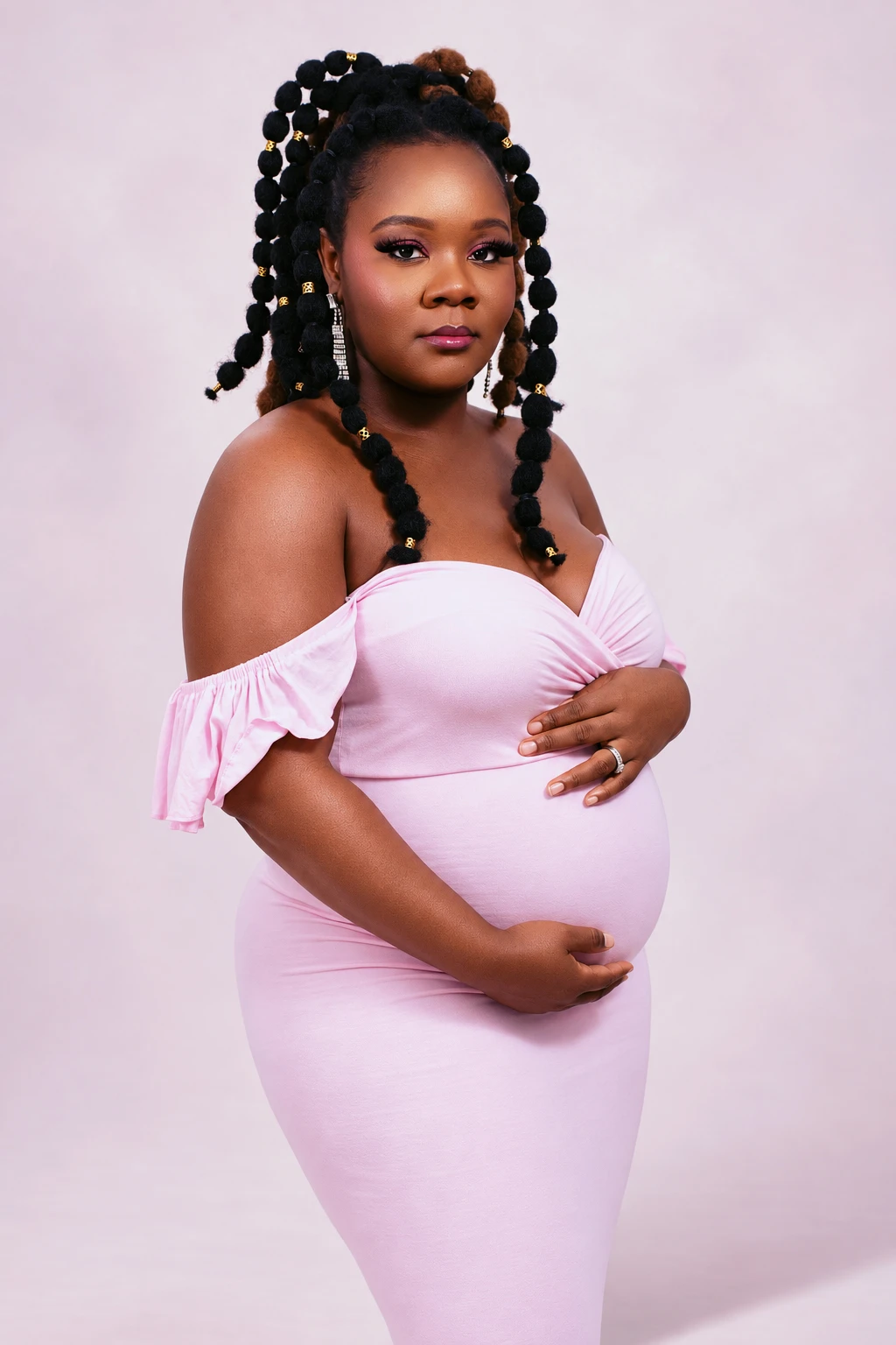 Close-up maternity portrait in a pink gown