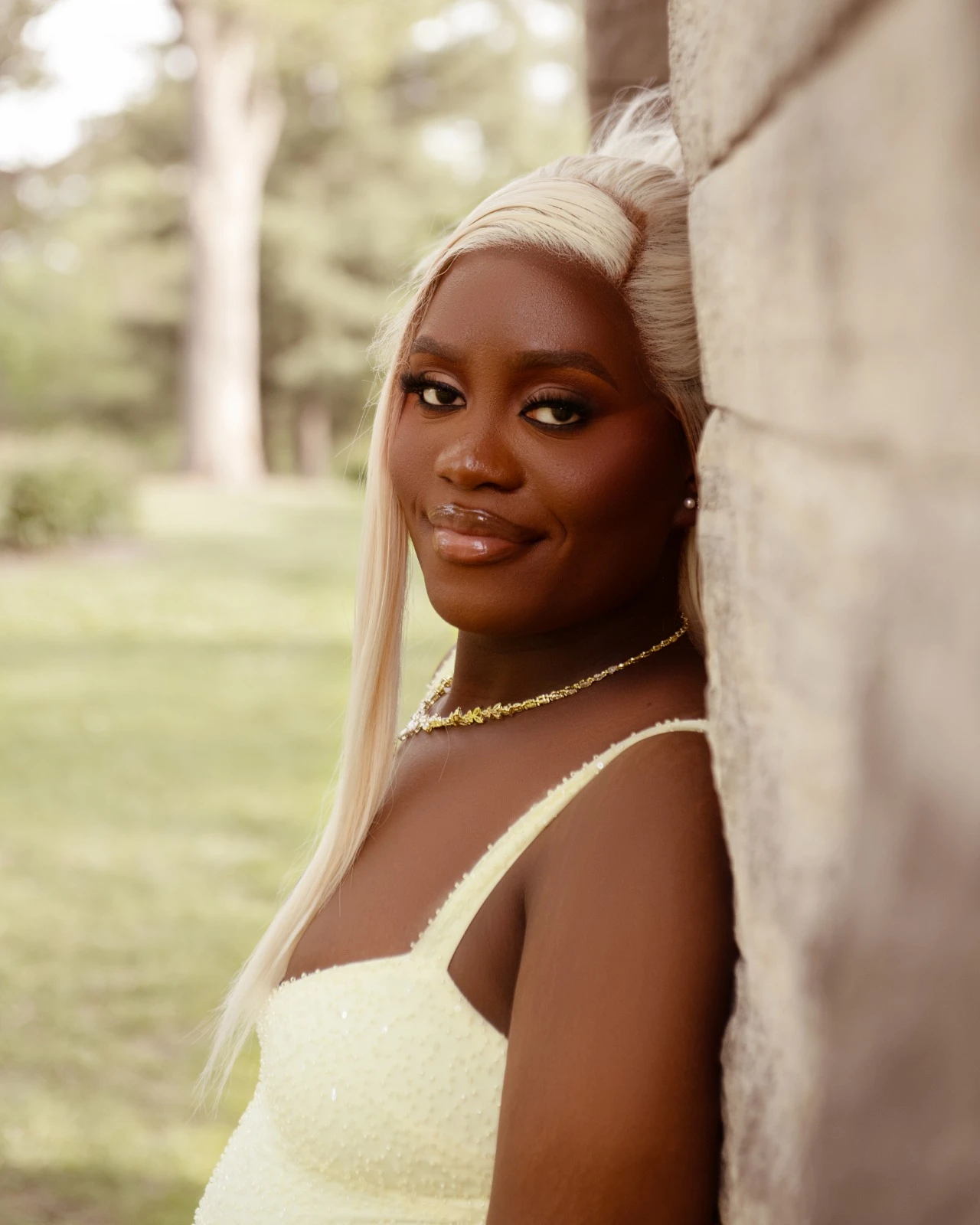 A close-up portrait leaning against a stone column