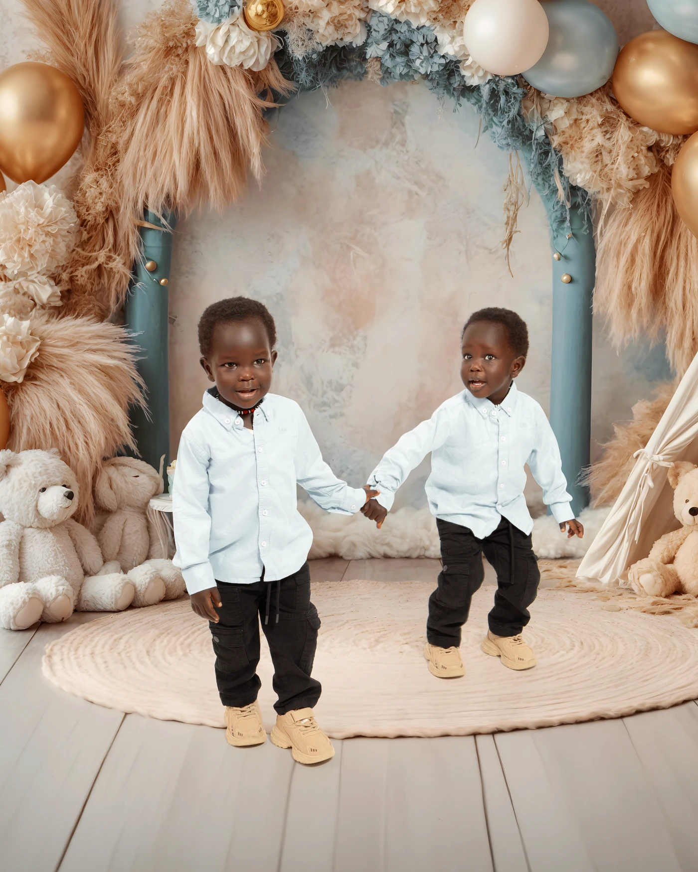 Two children holding hands in a birthday portrait setting