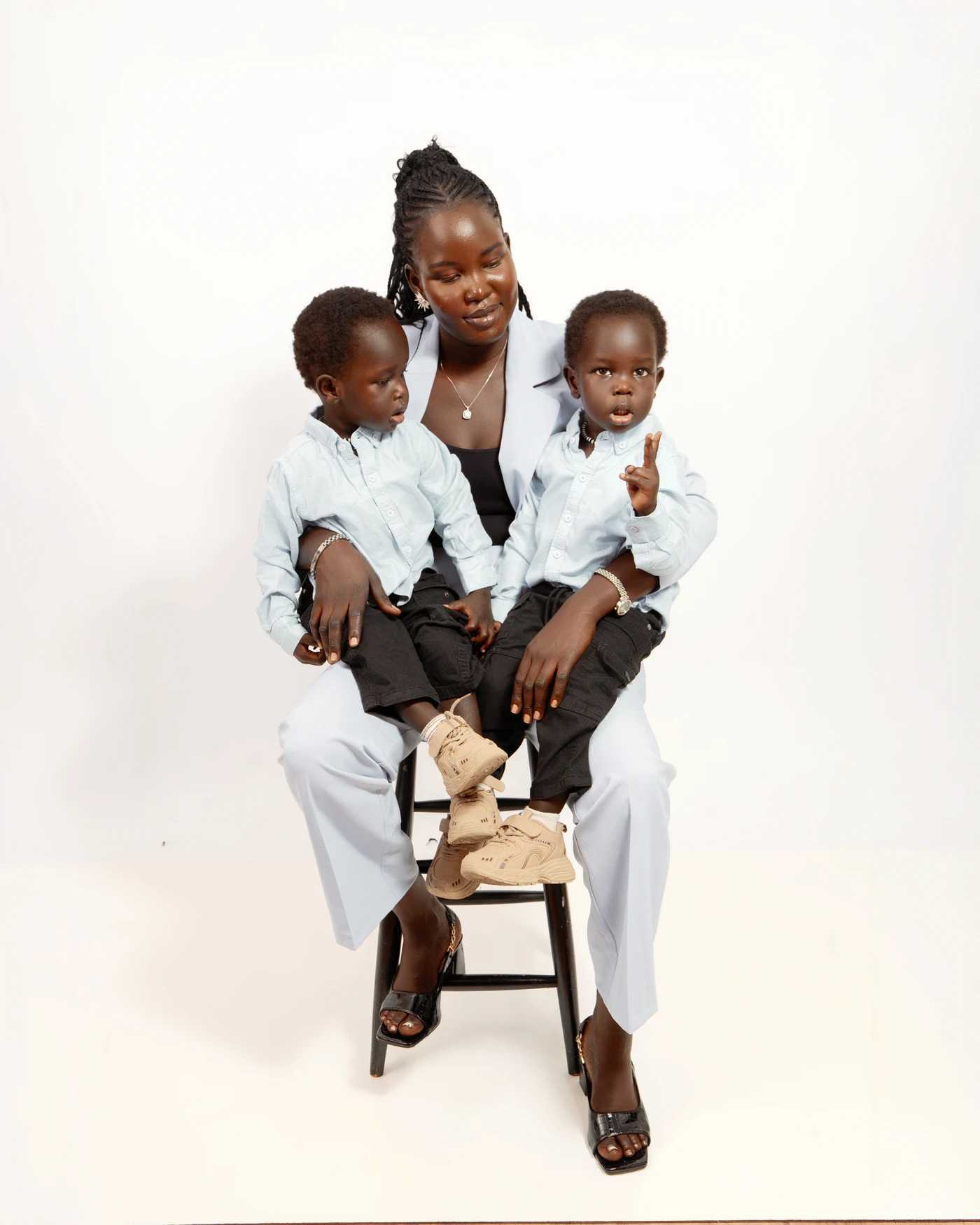 A mother holding her two children during a family portrait session